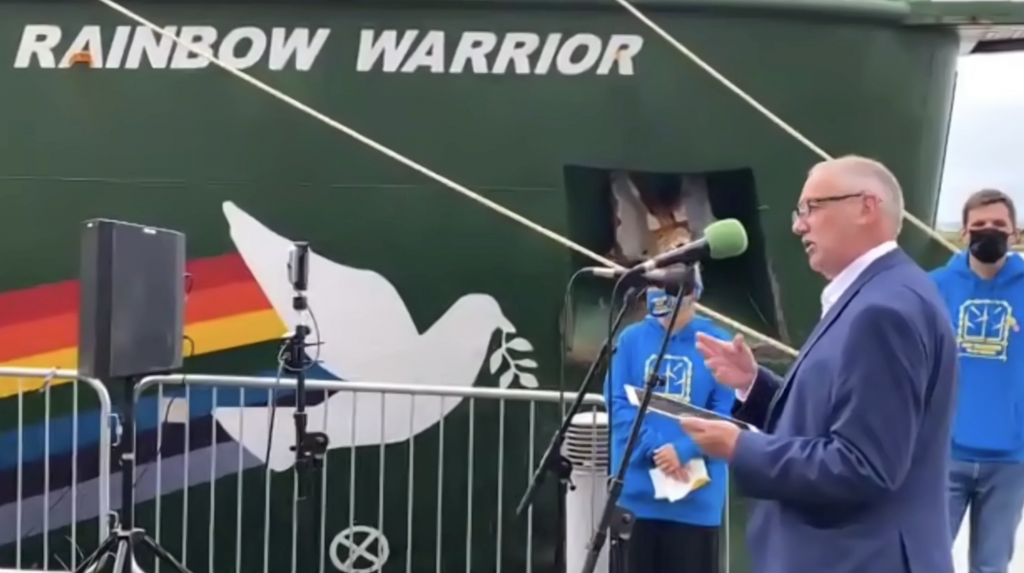 Paul speaking in front of the Rainbow Warrior